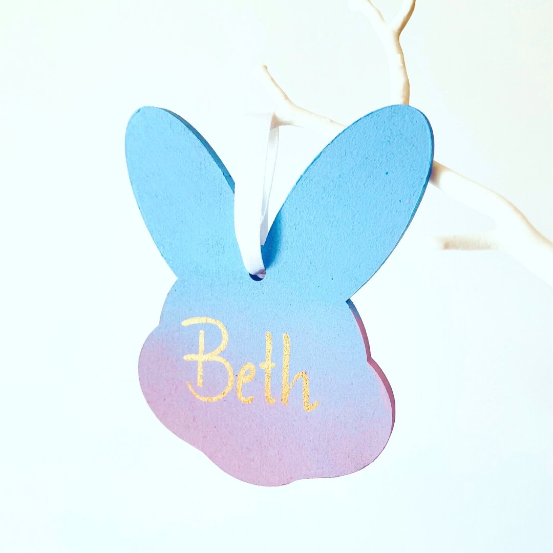 Blue & Purple Ombre Easter Bunny Head personalised with name hung by white satin ribbon from a white twig tree.